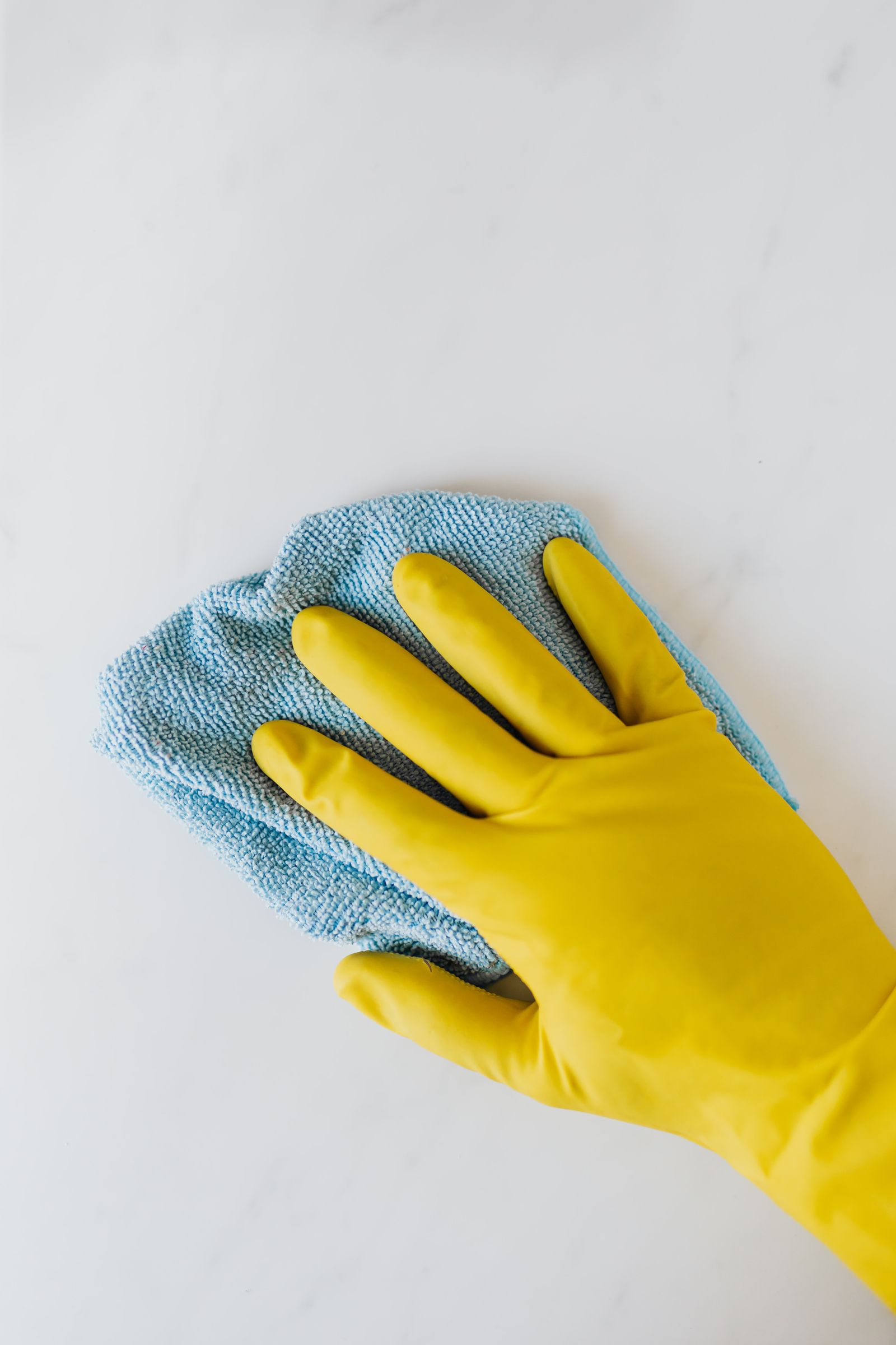 Gloved hand cleaning a surface
